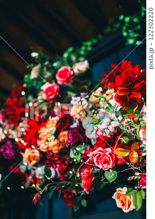 artificial flowers attached to a black lattice. photo zone decoration with flowers artificial flowers attached to a black lattice. photo zone decoration with flowers 122302220