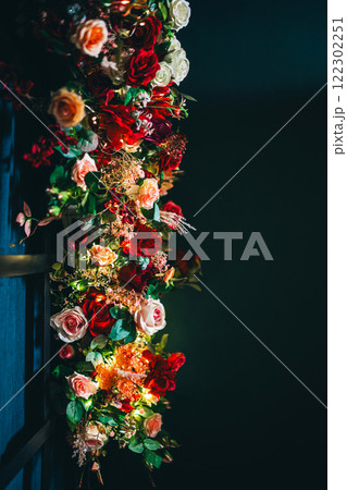 artificial flowers attached to a black lattice. photo zone decoration with flowers artificial flowers attached to a black lattice. photo zone decoration with flowers 122302251