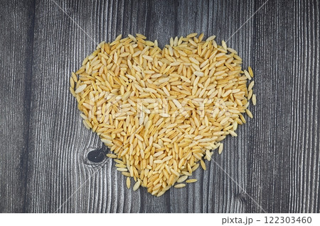 Raw fresh and healthy dry organic barley noodle on wooden spoon Raw fresh and healthy dry organic barley noodle on wooden spoon 122303460