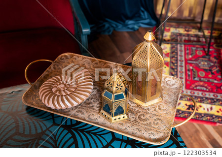 arabic lanterns on metal tray. muslim candlesticks on table arabic lanterns on metal tray. muslim candlesticks on table 122303534