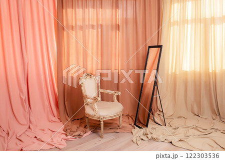wooden chair with black mirror of colored fabrics. photo zone with pieces of fabrics and furniture wooden chair with black mirror of colored fabrics. photo zone with pieces of fabrics and furniture 122303536