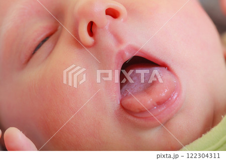 Closeup of newborn baby face, mouth open 122304311