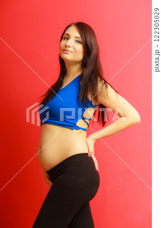 Long hair fit pregnant woman on red 122305029