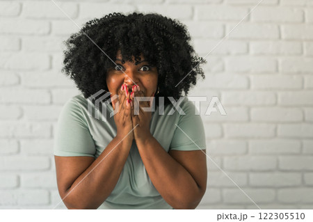African American woman expressing pure joy with an enthusiastic and open expression. Excitement, energy and contagious sense of positivity 122305510