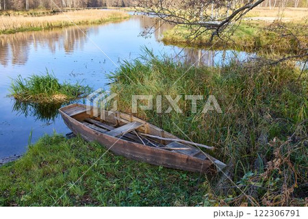 Abandoned Wooden Boat on Overgrown Riverbank Abandoned Wooden Boat on Overgrown Riverbank 122306791