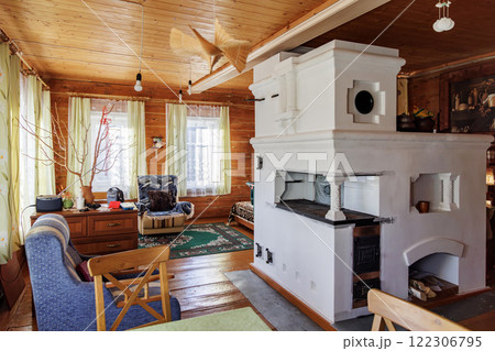 Traditional Russian Stove in Cozy Wooden House Interior Traditional Russian Stove in Cozy Wooden House Interior 122306795