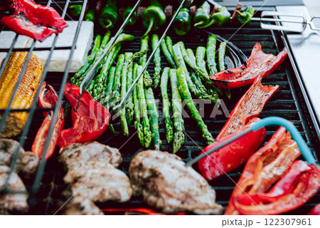 Cooking of meat and vegetables on a grill or on barbeque with temperature check. 122307961
