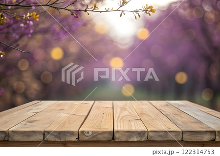 Photorealistic image of a wooden table top with a blurred background of a bright, sunny forest 122314753