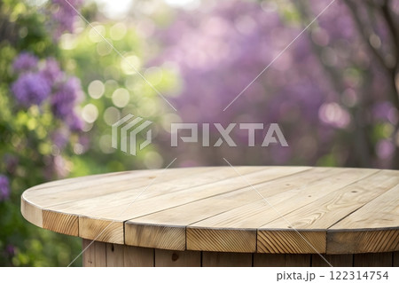 Photorealistic image of a wooden table top with a blurred background of a bright, sunny forest 122314754