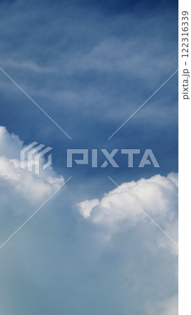 Blue Sky Background And White Clouds Soft Focus. Blue Sky Is Covered By White Clouds. Vertical Time Lapse. Blue Sky Background And White Clouds Soft Focus. Blue Sky Is Covered By White Clouds. Vertical Time Lapse. 122316339