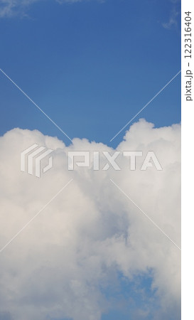 Blue Sky Background With Tiny Clouds. Low Angle View. Blue Clear Sky And White Clouds. Vertical Time Lapse. 122316404