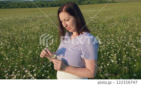 Privacy With Nature. Female With Fresh Blossom Bouquet Flowers In Sunlight At Sunset. Lady Face With Fresh Spring Chamomiles Bouquet At Blue Sky Background. Gimbal Stabilize. Privacy With Nature. Female With Fresh Blossom Bouquet Flowers In Sunlight At Sunset. Lady Face With Fresh Spring Chamomiles Bouquet At Blue Sky Background. Gimbal Stabilize. 122316747