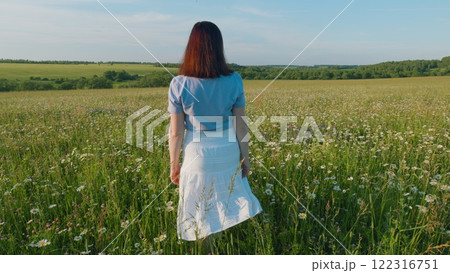 Holidays Weekend Adventure. Portrait - Countryside Woman Hold Flowers In Rural Nature. Magical Landscape With Wildflower Field, Travel And Spring Concept. Steadicam Shot. Holidays Weekend Adventure. Portrait - Countryside Woman Hold Flowers In Rural Nature. Magical Landscape With Wildflower Field, Travel And Spring Concept. Steadicam Shot. 122316751
