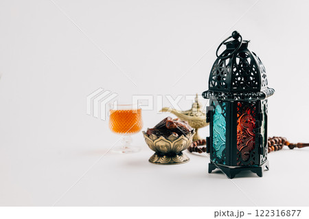 Holy Ramadan setup with dates in an ornate bowl, decorative lantern, and vintage lamp Holy Ramadan setup with dates in an ornate bowl, decorative lantern, and vintage lamp 122316877