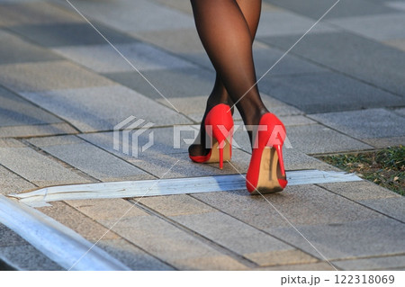 赤いハイヒールを履いた女性の足　赤いピンヒール 122318069