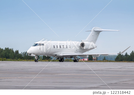 White luxury business jet taxiing on airport taxiway 122318442