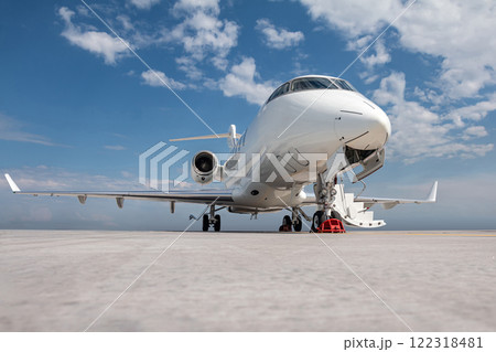 Modern white executive airplane with an opened gangway door at the airport apron 122318481