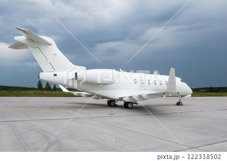 Modern white executive aircraft on the airport apron on a cloudy day 122318502