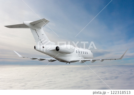 White luxury private jet flying in the air above the clouds White luxury private jet flying in the air above the clouds 122318513