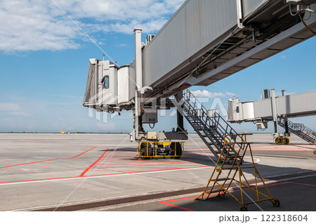 Empty passenger air bridges at airport apron Empty passenger air bridges at airport apron 122318604