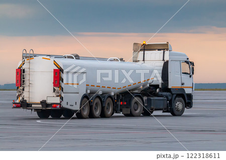 White tank truck aircraft refueler at the airport apron White tank truck aircraft refueler at the airport apron 122318611