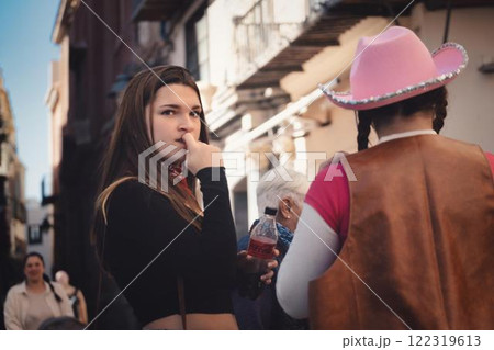 Young woman in contemplation on a bustling city street, colourful characters and urban environment in the background. Young woman in contemplation on a bustling city street, colourful characters and urban environment in the background. 122319613