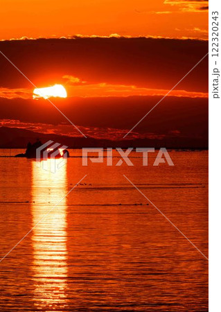 夕焼けを背景に風流島（たわれじま）光の道を渡る海鳥「枕草子や伊勢物語など平安時代の書物に登場」宇土市 122320243