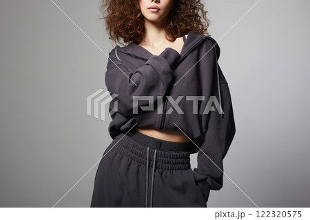 fashionable beautiful young woman in tracksuit of hoodie and trousers fashionable beautiful young woman in tracksuit of hoodie and trousers 122320575