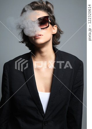 Smoking Beautiful woman with short hair in sunglasses 122320614