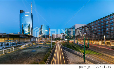 Milan skyline with modern skyscrapers in Porta Nuova business district day to night timelapse in Milan, Italy, after sunset. Milan skyline with modern skyscrapers in Porta Nuova business district day to night timelapse in Milan, Italy, after sunset. 122321935