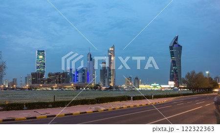 Skyline with Skyscrapers day to night timelapse in Kuwait City downtown illuminated at dusk. Kuwait City, Middle East Skyline with Skyscrapers day to night timelapse in Kuwait City downtown illuminated at dusk. Kuwait City, Middle East 122322363