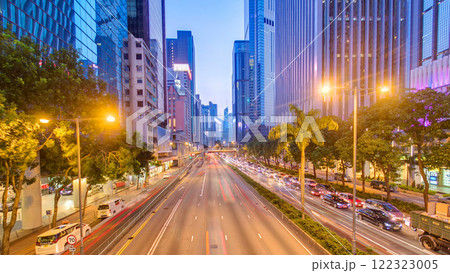 Hong Kong street with busy traffic and skyscraper office at dusk day to night timelapse. Hong Kong street with busy traffic and skyscraper office at dusk day to night timelapse. 122323005
