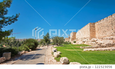 Defensive wall of the ancient holy Jerusalem timelapse hyperlapse, lit by the bright sun. 122323056