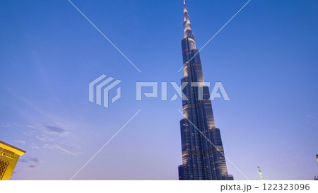 Bridge and fountains with Burj Khalifa day to night transition, Dubai, Emirates timelapse 122323096