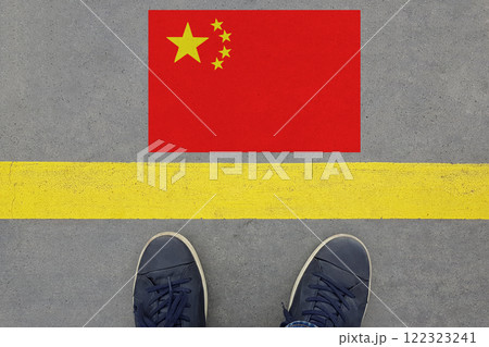 Word Start on an asphalt road with the Chinese flag and legs in shoes. Word Start on an asphalt road with the Chinese flag and legs in shoes. 122323241