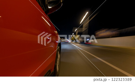 Drivelapse from side of car moving on a night avenue in city timelapse hyperlapse 122323389