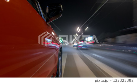 Drivelapse urban look from fast driving car at a night avenue in a city timelapse hyperlapse 122323398