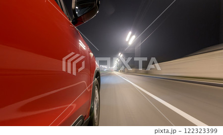 Drivelapse urban look from fast driving car at a night avenue in a city timelapse hyperlapse 122323399
