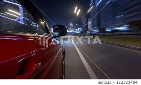 Drivelapse urban look from fast driving car at a night avenue in a city timelapse hyperlapse 122323404