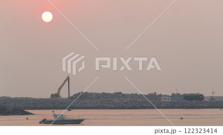 Relaxing Sunset in Dubai near beach. Calm sea and boat floating in Dubai timelapse 122323414