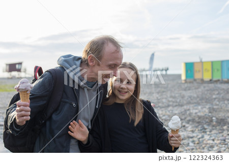 Carefree family. Cute child and father walking and enjoying ice cream at sunny day. 122324363