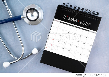 March 2025 desk calendar and stethoscope, Medical appointment schedule to check up. March 2025 desk calendar and stethoscope, Medical appointment schedule to check up. 122324585
