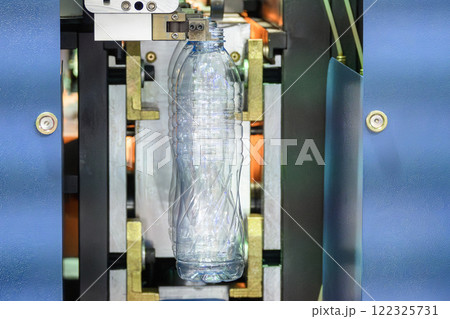 The drinking water bottle manufacturing process by blow mold machine. 122325731