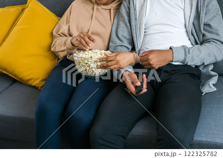 Remote control is pointed toward the television screen, control and choice of tv entertainment. TV, series and streaming service concept Remote control is pointed toward the television screen, control and choice of tv entertainment. TV, series and streaming service concept 122325782