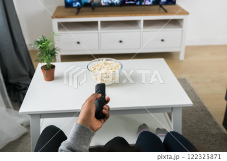 Remote control is pointed toward the television screen, control and choice of tv entertainment. TV, series and streaming service concept 122325871