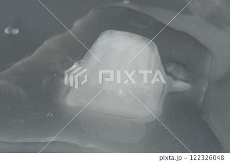 Melting ice cube Melting ice cube 122326048
