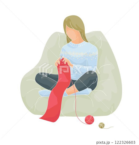 woman sits in a chair and knits a red scarf 122326603