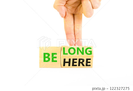 Belonging and belong symbol. Concept words Be here Belong on beautiful wooden block. Beautiful white background Businessman hand. Business motivational belonging and belong concept. Copy space. 122327275