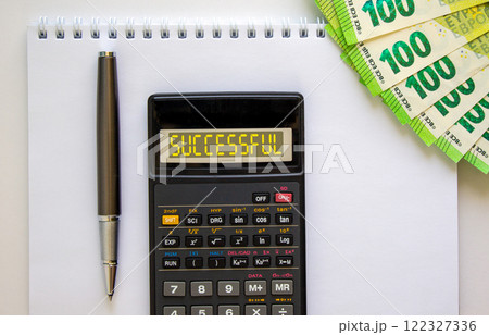 Successful symbol. Concept word Successful on beautiful black calculator. Beautiful white background. Euro bills. Black pen. Business successful concept. Copy space. 122327336