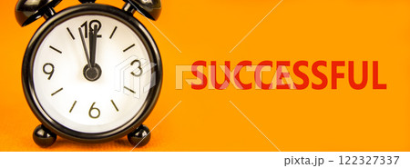 Successful symbol. Concept word Successful on beautiful orange paper. Beautiful orange paper background. Black alarm clock. Business successful concept. Copy space. 122327337